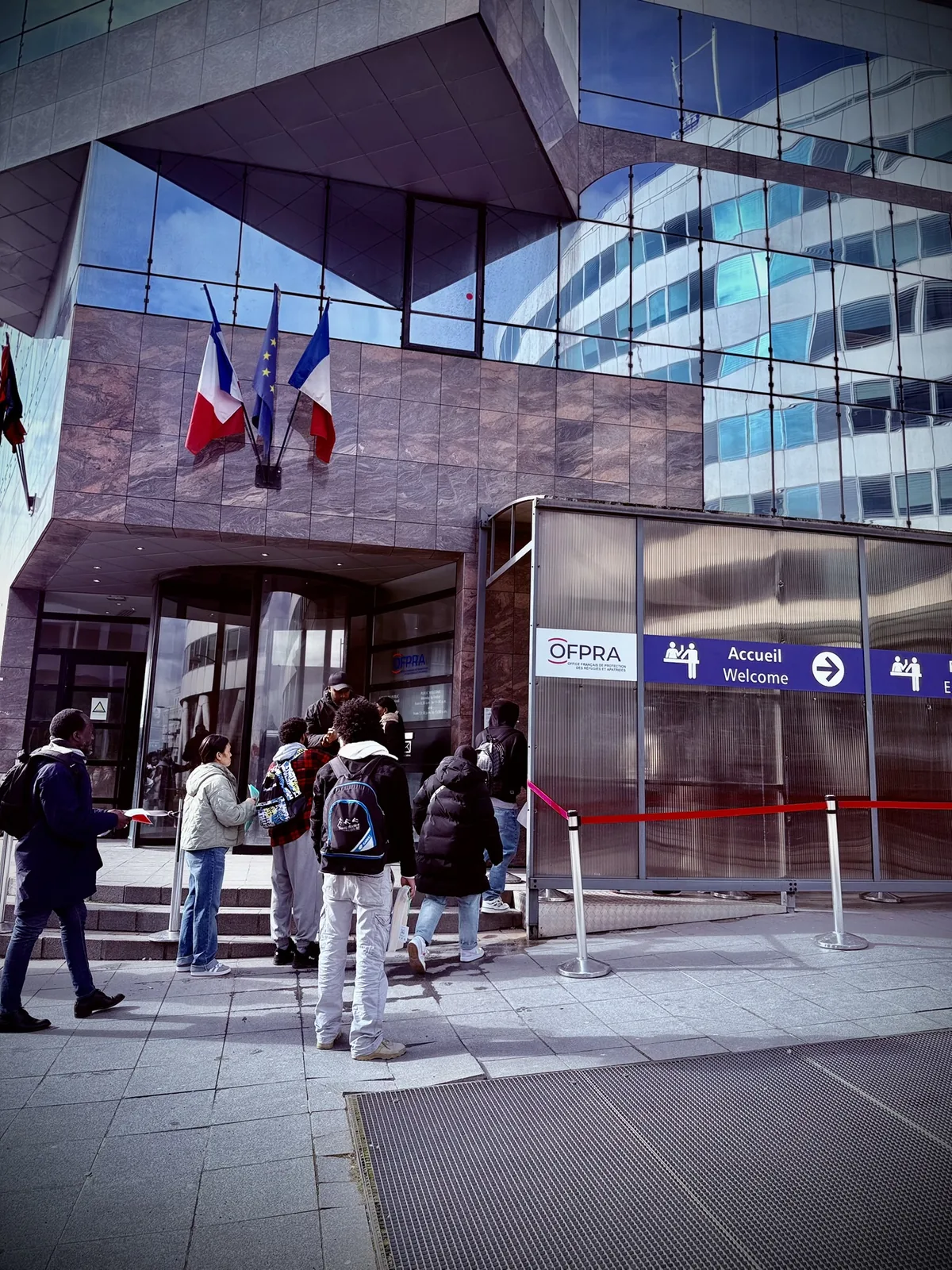 Entrance to the French Office for the Protection of Refugees and Stateless Persons, with French and EU flags