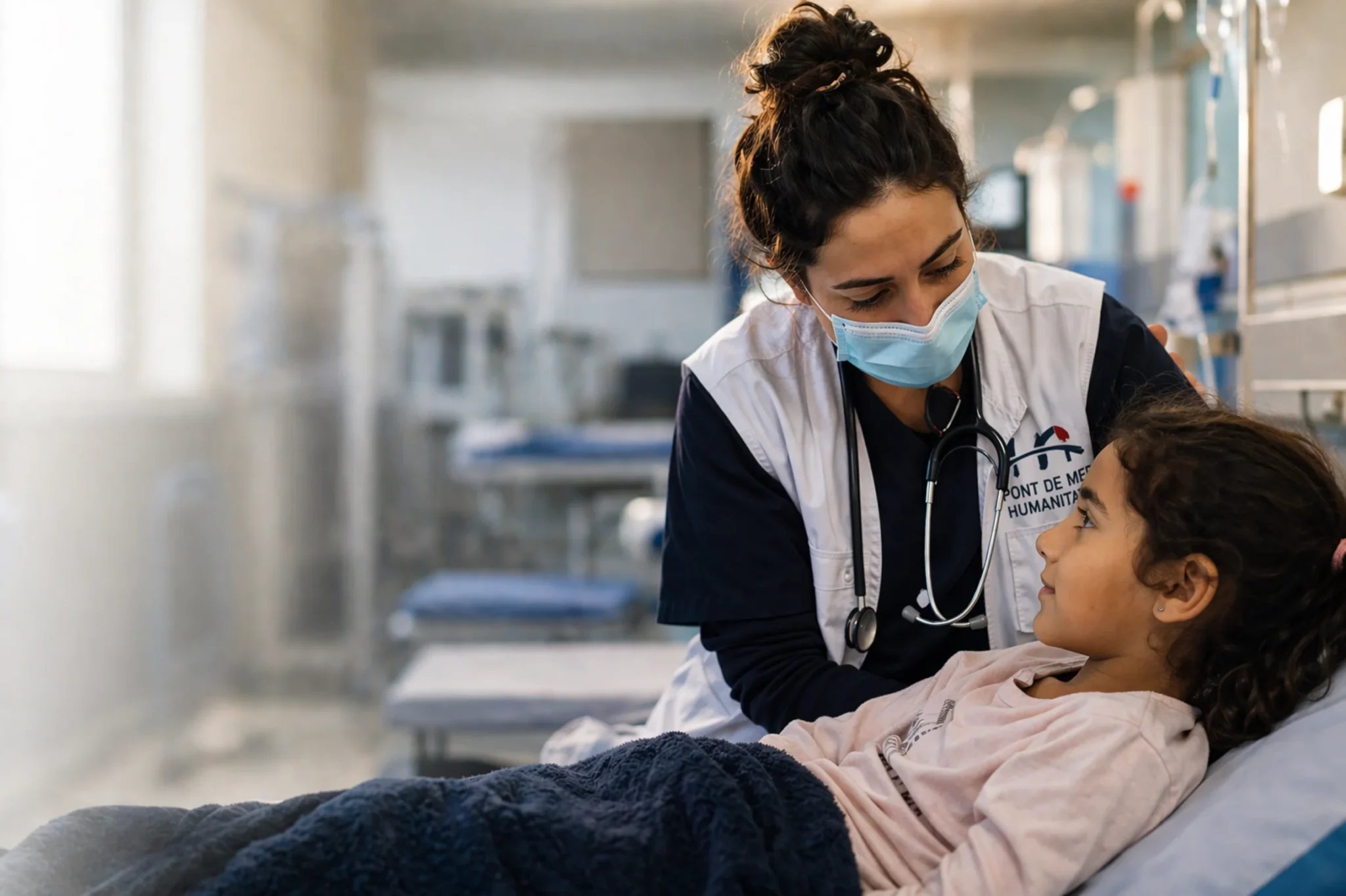 Healthcare professional supporting a young patient through her care pathway