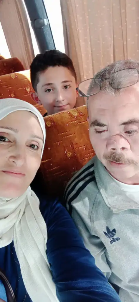 Family travelling by bus during an evacuation from Rafah.